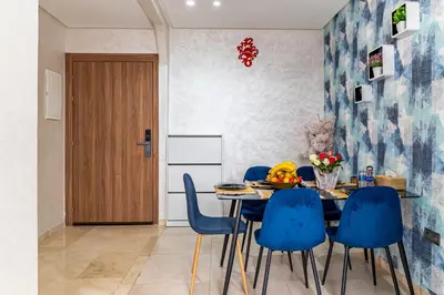 a dining room with a table and blue chairs at 5 Star City Oasis Modern and Cozy in Marrakech