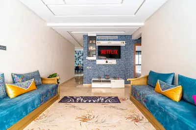 a living room with blue couches and a tv at 5 Star City Oasis Modern and Cozy in Marrakech