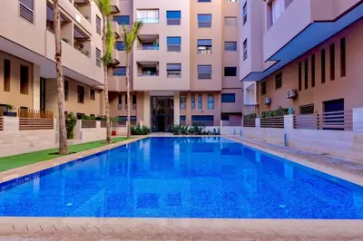 a swimming pool in front of a building at 5 Star City Oasis Modern and Cozy in Marrakech