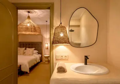 a bathroom with a sink and a bed and a mirror at Apartment in Gueliz, Riad style, equipped and central in Marrakech