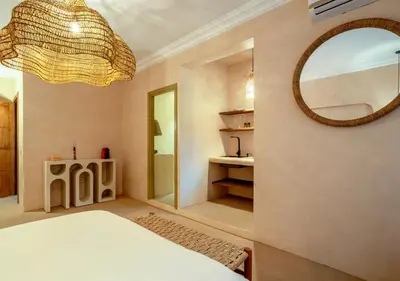a bedroom with a white bed and a mirror at Apartment in Gueliz, Riad style, equipped and central in Marrakech