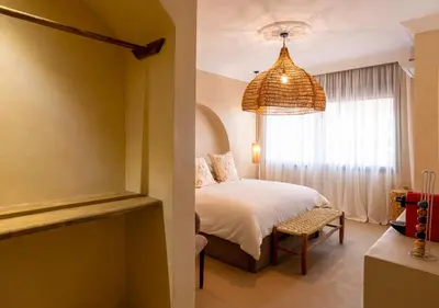 a bedroom with a bed and a large window at Appartement à Guéliz, style Riad, équipé & central in Marrakech
