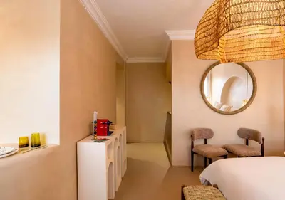 a bedroom with a bed and a mirror and a table at Appartement à Guéliz, style Riad, équipé & central in Marrakech
