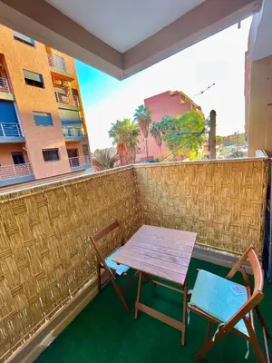 a table and two chairs sitting on a balcony at 5-Star Hidden Gem in Marrakech in Marrakech