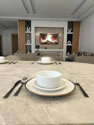 a table with a plate and utensils on it at Villa Moderne 5 chambres vue sur Atlas in Marrakech