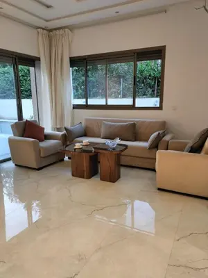 a living room with couches and tables and windows at Villa Moderne 5 chambres vue sur Atlas in Marrakech