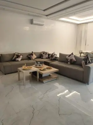 a living room with a couch and a coffee table at Villa Moderne 5 chambres vue sur Atlas in Marrakech