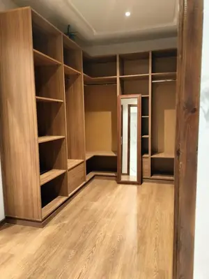 an empty room with wooden shelves and a door at Villa Moderne 5 chambres vue sur Atlas in Marrakech