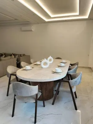 a table in a room with chairs around it at Villa Moderne 5 chambres vue sur Atlas in Marrakech