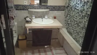 a bathroom with a sink and a shower and a tub at A Cosy Maison avec un accès direct à la piscine in Marrakech