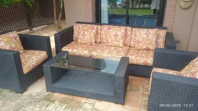 a couch and two chairs and a table on a patio at A Cosy Maison avec un accès direct à la piscine in Marrakech