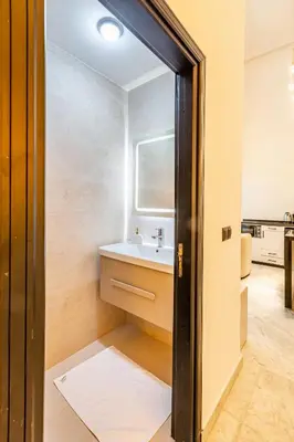 a bathroom with a sink and a mirror at Duplex Confort, Jacuzzi à 5min de Majorelle&Médina in Marrakech