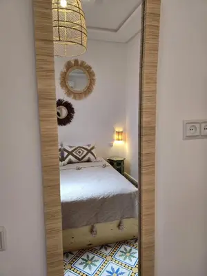 a mirror in a bedroom with a bed in it at Dar laarbi Kasbah in Marrakech