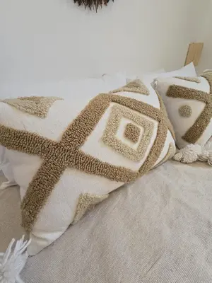 a bed with two pillows with a star pattern at Dar laarbi Kasbah in Marrakech
