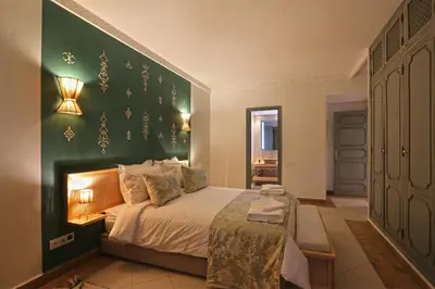 a bedroom with a bed with a green wall at Spacious 3Br Apartment-Pool&AC- Heart of Marrakech- Hivernage in Marrakech
