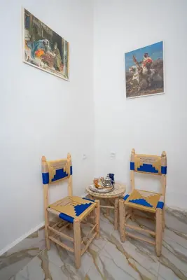 two chairs and a table in a room at Studio Blue Majorelle Marrakech in Marrakech