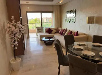 a living room with a couch and a table at Appartement Marrakech in Marrakech