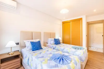 a bedroom with two beds with blue pillows at Luxury House avec Piscine et Terrasse in Marrakech