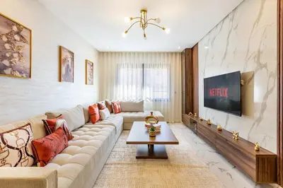 a living room with a couch and a tv at Luxury House avec Piscine et Terrasse in Marrakech