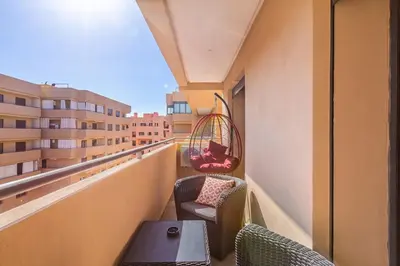 a balcony with a chair and a table on a building at Luxury House avec Piscine et Terrasse in Marrakech