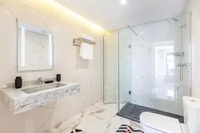 a bathroom with a sink and a glass shower at Luxury House avec Piscine et Terrasse in Marrakech