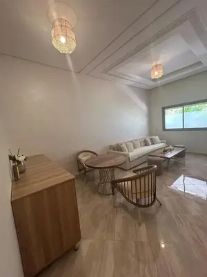 a living room with a couch and a table at Appartement Haut Standing in Marrakech