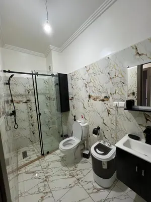 a bathroom with a shower and a toilet and a sink at Jardin chrifiya in Marrakech