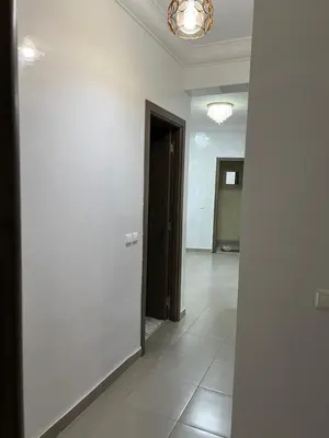 an empty room with a door and a hallway at Jardin chrifiya in Marrakech