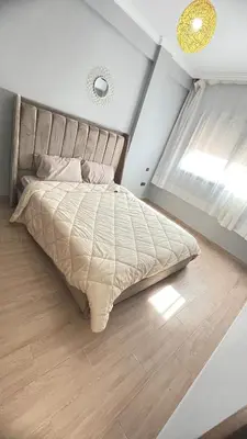 a bedroom with a large bed with a large window at Lovely apartment N15 in Marrakech