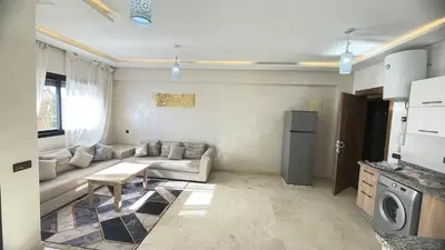 a living room with a couch and a refrigerator at Lovely apartment N15 in Marrakech