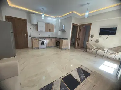 a large kitchen with a washer and dryer at Lovely apartment N15 in Marrakech