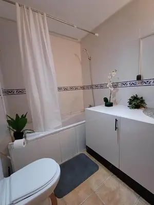 a bathroom with a toilet and a tub and a sink at Gueliz Appartement in Marrakech