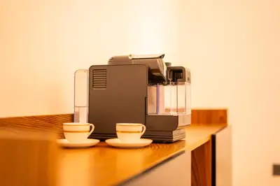 a coffee machine sitting on a counter with two cups at Villa Jnan Targa Pool & Garden in Marrakech