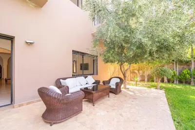 a patio with two couches and a table at Villa Jnan Targa Pool & Garden in Marrakech