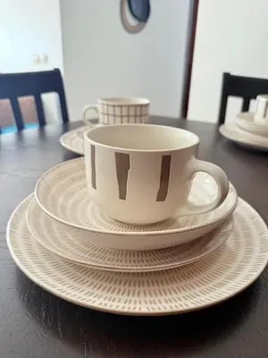 a coffee cup and plates on a table at Appartement Moderne & Spacieux au Cœur de Guéliz et Proche Majorelle in Marrakech