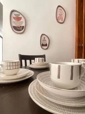 a table with white cups and plates on it at Appartement Moderne & Spacieux au Cœur de Guéliz et Proche Majorelle in Marrakech