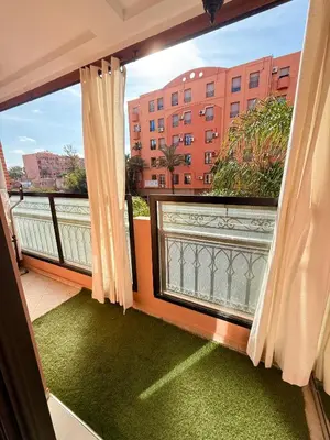 a balcony with a view of a building at Appartement Moderne & Spacieux au Cœur de Guéliz et Proche Majorelle in Marrakech