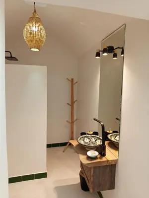 a bathroom with a mirror and a wooden table at Minka Marishan exclusif Riad in Royal destrict in Marrakech
