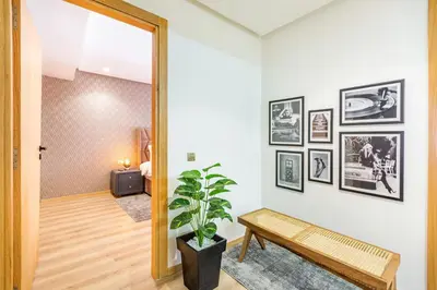 a hallway with a bench and pictures on the wall at Joli cocon à Marrakech Balcon privé et confort in Marrakech