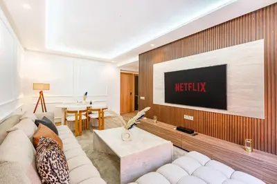 a living room with a couch and a tv on a wall at Joli cocon à Marrakech Balcon privé et confort in Marrakech
