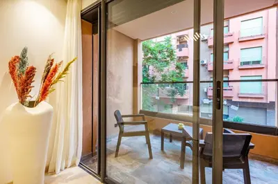 a room with a table and a chair and a window at Central Gueliz 1-bedroom apartment in Marrakech