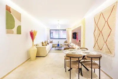 a living room with a table and chairs at Central Gueliz 1-bedroom apartment in Marrakech