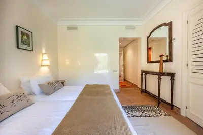 a bedroom with a bed and a mirror and a table at Chez fatina in Marrakech
