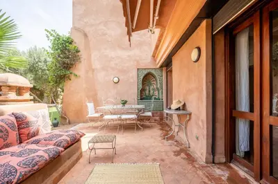 an outdoor patio with a table and chairs at Chez fatina in Marrakech