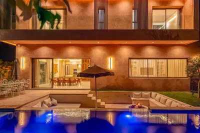 a house with a pool in front of a house at Villa Nabil by TheCasaEdition Cinema, Heated pool & Jaccuzi in Marrakech
