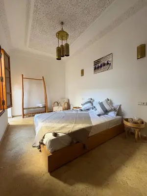 a bedroom with a large bed in a room at Riad Amanar in Marrakech