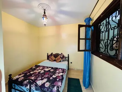 a bedroom with a bed and a window at Cozy room in marrakech in Marrakech