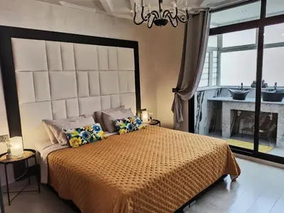 a bedroom with a large bed and a fireplace at Splendid One Bedroom center of Marrakech -Gueliz- in Marrakech