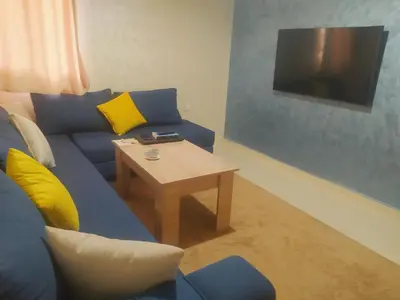 a living room with a blue couch and a table at Apartment Targa Reserved for Families in Marrakech