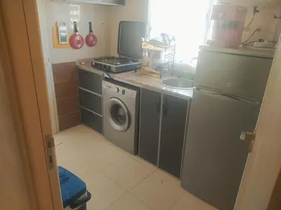 a kitchen with a refrigerator and a washing machine at Apartment Targa Reserved for Families in Marrakech